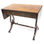 A mahogany sofa table in Regency style, the rectangular quarter veneered top with a cross banded and