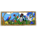 A rectangular stained glass panel, decorated with flowers and birds in the Art Nouveau style, etched