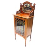 An Edwardian mahogany and marquetry music cabinet, the glazed back with a cartouche shaped plate,