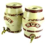 A pair of 19thC stoneware spirit barrels, for rum and gin, each with a brass tap, decoration (AF),