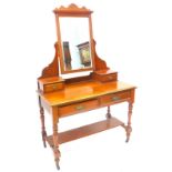 A late Victorian walnut dressing table, the top with a bevelled mirror plate on shaped supports with