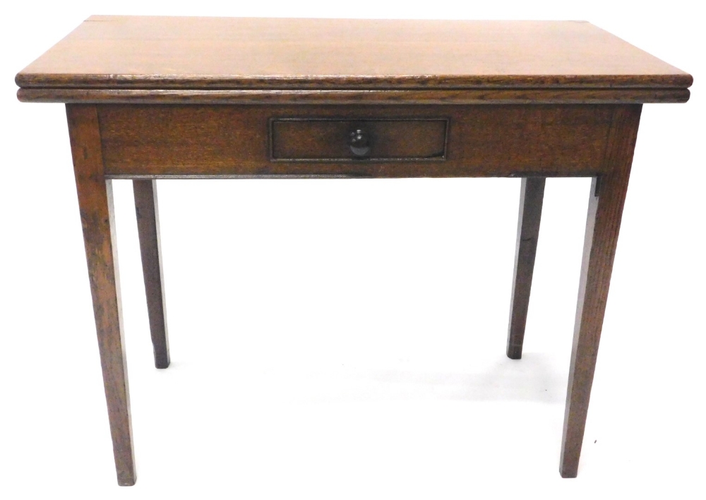 A 19thC oak tea table, the rectangular top enclosing polished surface above a small frieze drawer on