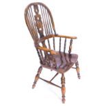 An ash and elm Windsor chair, with a pierced splat, solid seat on turned legs with H stretcher.