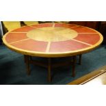 An unusual mahogany circular boardroom or dining table, the top inset with red leatherette segments,