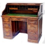 A William Richardson oak roll top desk, with fitted interior, green leatherette writing surface