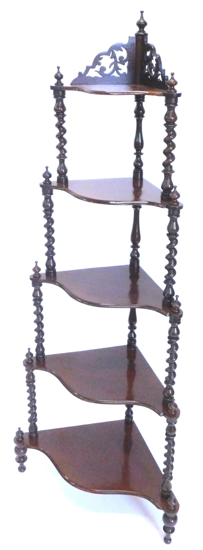 A Victorian mahogany corner what not, the top with a fret carved frieze on spirally turned