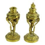 A pair of late 19thC French gilt metal cassolettes, each cast with flame finial, scrolls, swags