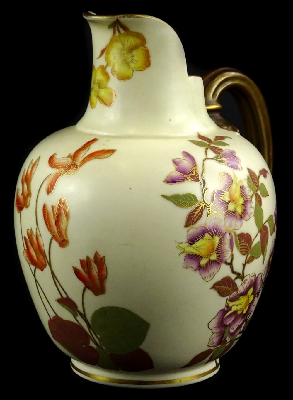 A Royal Worcester porcelain ewer, decorated with flowers in the oriental style, picked out in
