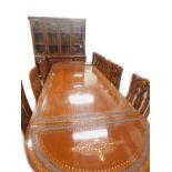 An Eastern hardwood brass and copper inlaid extending dining table, comprising two D shaped ends,