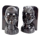 A pair of African tribal bookends, each carved with a male and female bust, 23cm H.