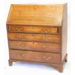 A George III oak bureau, the fall enclosing a fitted interior, above four graduated drawers with