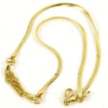 An 18ct gold necklace, with fine link design drop area, and cross ball links, on articulated