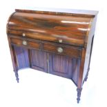 A 19thC ladies writing desk, the cylinder front enclosing a fitted interior, with a hinged leather
