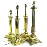 A collection of four brass column table lamps, each on a square base, the largest 54cm H.