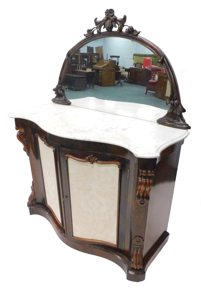 A Victorian rosewood side cabinet, the raised demi lune shaped back with a carved moulded frame,