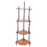 A Victorian walnut three tier corner what-not, each section with marquetry urn, on turned