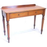 A Victorian mahogany side table, with a raised back above two frieze drawers on turned tapering