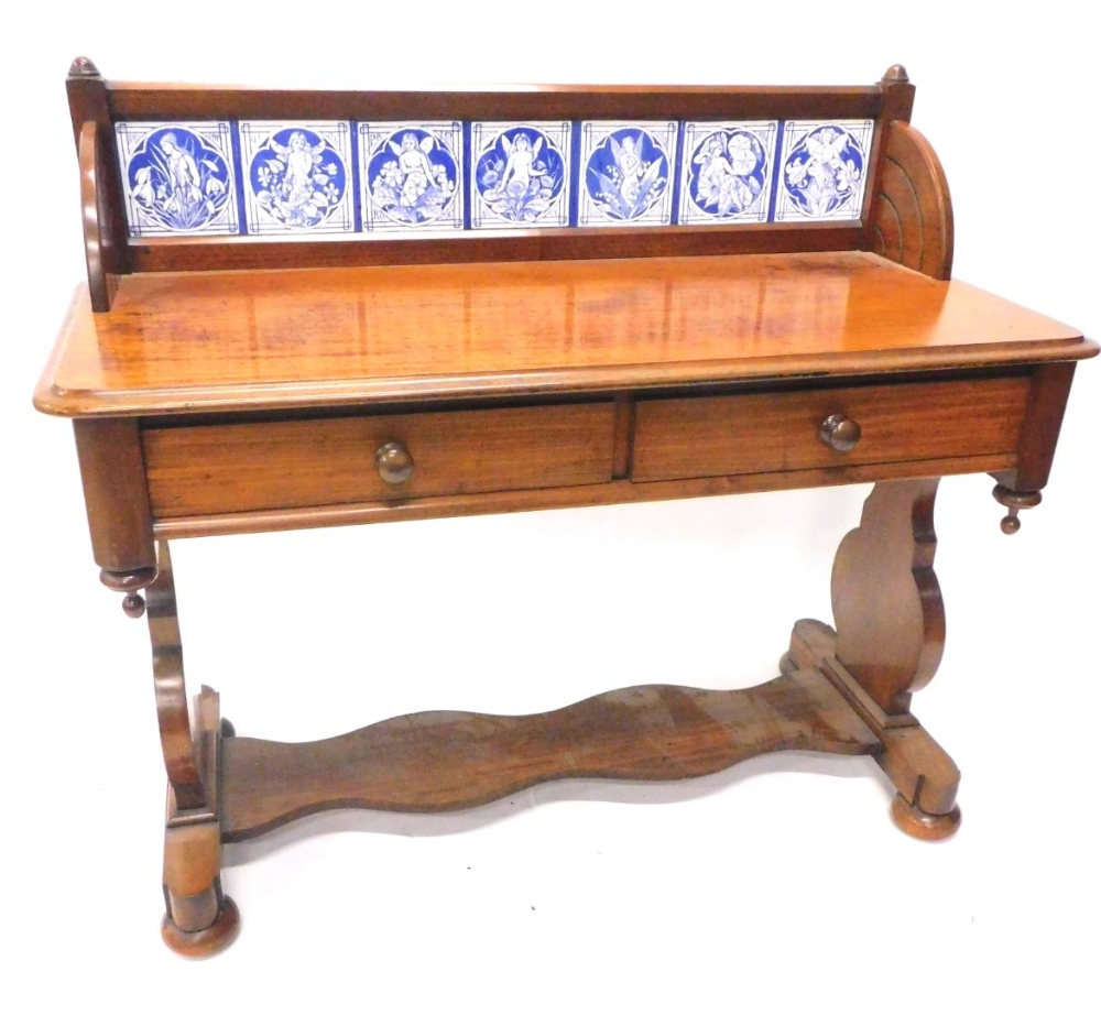 A Victorian mahogany washstand, the raised back inset with seven Minton type tiles, each decorated