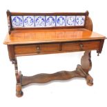 A Victorian mahogany washstand, the raised back inset with seven Minton type tiles, each decorated