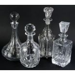 A collection of four decanters and stoppers, to include a 19thC example with waisted body, 32cm H.