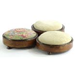 Three Victorian walnut foot stools, to include an example with a padded woolwork seat and a