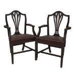 A set of six 19thC mahogany dining chairs, including two carvers, with Hepplewhite camel backs,