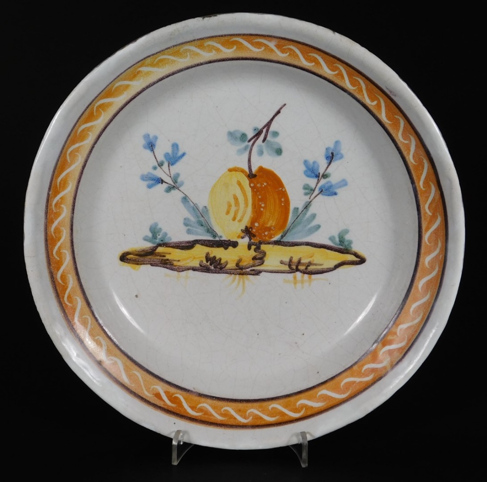 A tin glazed earthenware dish, of circular form, polychrome decorated with fruits and flowers, - Image 10 of 28