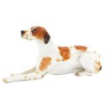 A Lomonosov porcelain figure of a pointer dog, modelled in recumbent pose, printed mark, 30cm L.