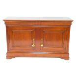 A chestnut sideboard, with two cushion drawers over a pair of cupboard doors, raised on a plinth