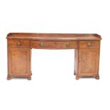 A George III mahogany bow front sideboard, with a three quarter galleried top, over a large bow