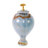 A studio pottery vase and cover, of baluster form, gilt decorated with fish and moulded with