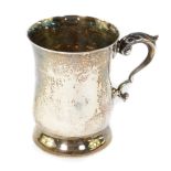 A silver tankard, of baluster form with a double scroll handle and embossed leaf thumb piece,