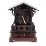 A German late 19thC oak cased cuckoo mantel clock, the circular dial bearing Roman numerals, eight