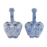 A near pair of Chinese Qing Dynasty blue and white tulip vases, of delft ware form long necked