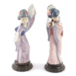 A pair of Lladro porcelain figures modelled as Japanese Geisha girls, raised on circular fluted