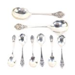 A George V silver fruit set, with pierced floral terminals, comprising two large and six small