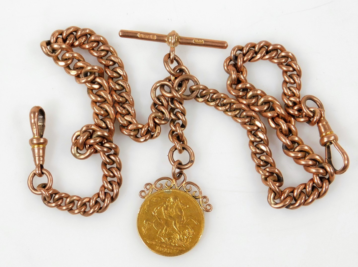 A 9ct gold chain and T bar, set with a gold 1918 sovereign with yellow metal mount,