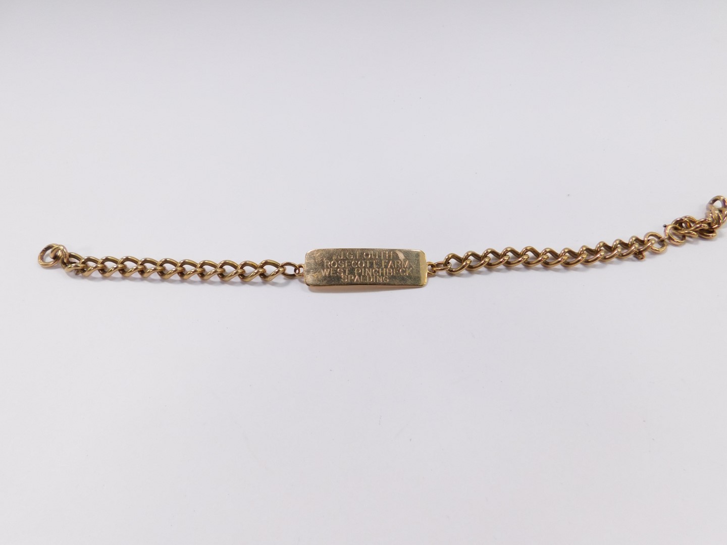 A 9ct gold curb link identity bracelet, clasp lacking, 24.3g.