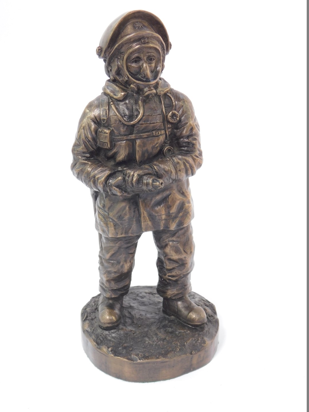 A late 20thC bronzed plaster figure modelled as a fire fighter, raised on a circular base, limited