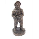 A late 20thC bronzed plaster figure modelled as a fire fighter, raised on a circular base, limited