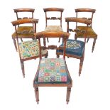 A set of six late Regency faux rosewood and oak single dining chairs, with floral carved back