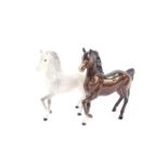 A Beswick Palomino prancing horse, together with a similar brown gloss prancing horse, printed marks