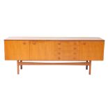 A Gimson and Slater Vesper teak sideboard, with a pair of cupboard doors, four short drawers and a