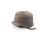 A Third Reich WWII Luftwaffe helmet, with an eagle and swastika decal, 23cm W.