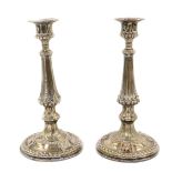 A pair of Victorian Elkington & Company silver plated candlesticks, embossed with beading, foliate