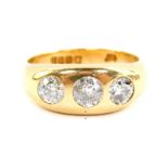 An 18ct gold and diamond gentleman's three stone gypsy ring, approx 1.6cts, size V/W, 11.0g all in.