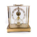 A Kundo brass cased skeleton clock, with silvered chapter ring bearing Arabic numerals,