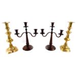 A pair of 19thC brass candlesticks, 29cm H, together with a pair of early 20thC brown and black