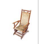 A Victorian pine American rocking chair, with turned frame, floral upholstered seat and back, on
