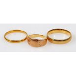 A 22ct gold wedding band, 2.1g, and two 9ct gold wedding bands, 4.3g.